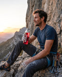 Rock climber holding EMBA bottle